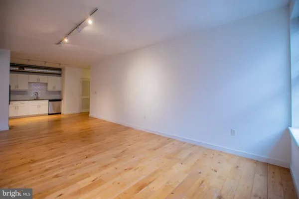 an empty room with a kitchen