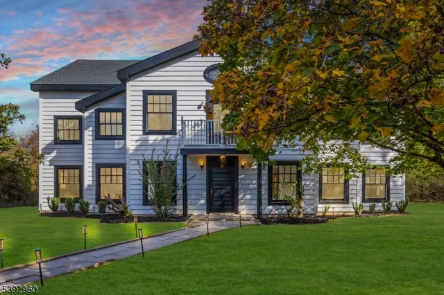 front view of a brick house with a yard