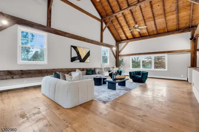 a living room with furniture a clock and white walls