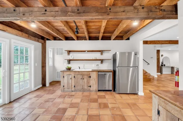 a spacious bathroom with a granite countertop sink and a mirror
