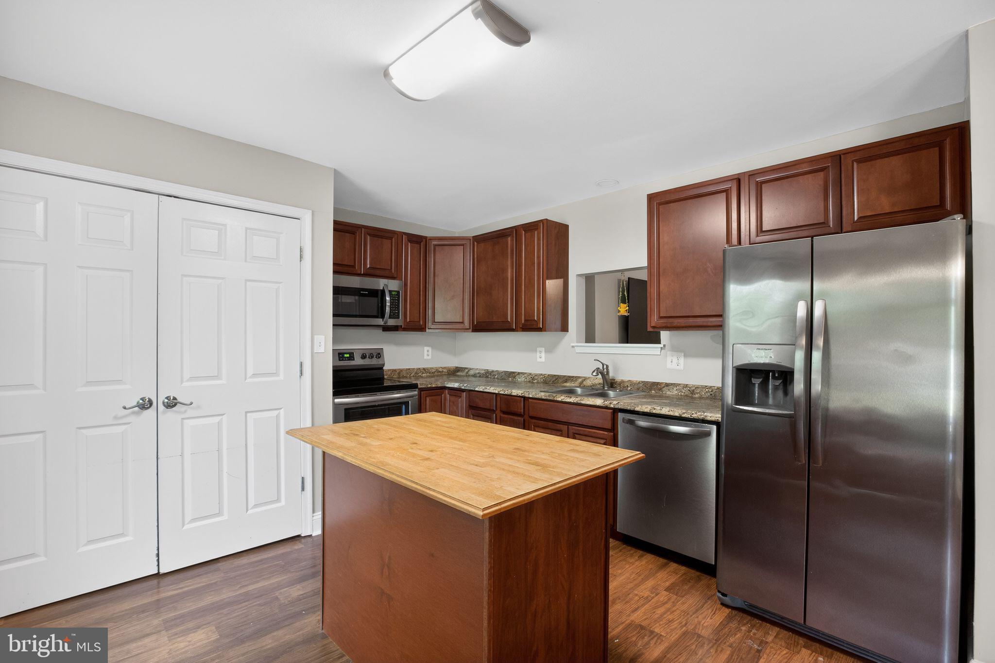 11789 Little Cove Point Road Lusby, MD 20657 - Photo 10 of 16 a kitchen with stainless steel appliances granite countertop a refrigerator a sink and dishwasher