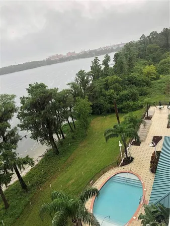 an aerial view of a house with a yard and lake view