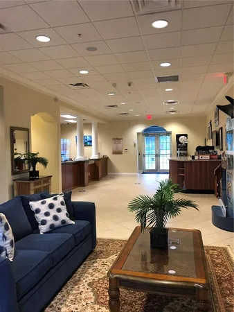 a living room with furniture and view of kitchen