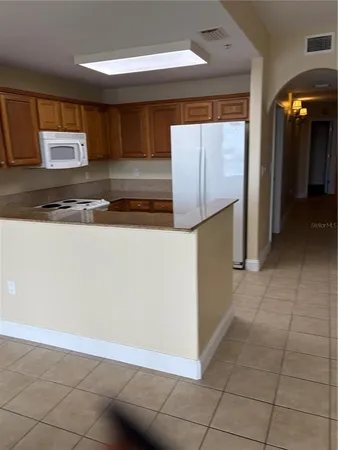 a kitchen with stainless steel appliances a counter top space