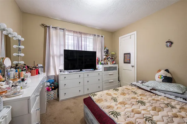 a bedroom with a bed and flat screen tv