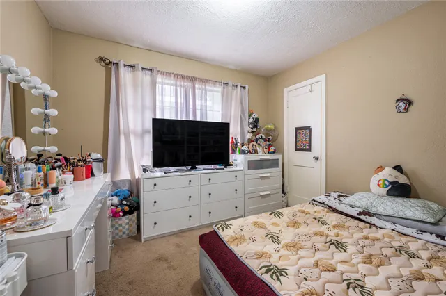 a bedroom with a bed and flat screen tv