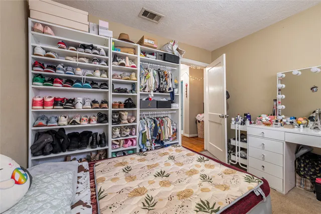 a bed room with a bed and a book shelf