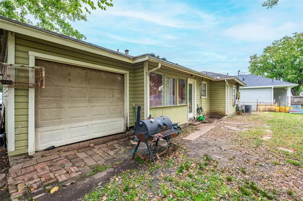 a backyard of a house with table and chairs