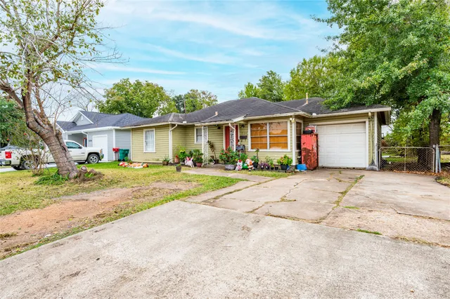 a front view of a house with a yard and a garage