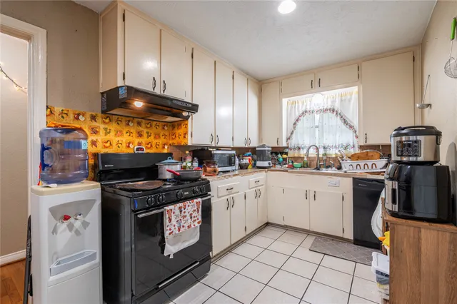 a kitchen with stainless steel appliances a stove a sink and a refrigerator