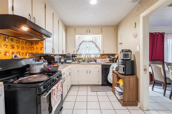 a kitchen with a sink a stove and a refrigerator