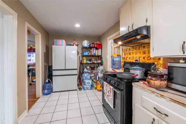 a kitchen with stainless steel appliances granite countertop a refrigerator and a stove