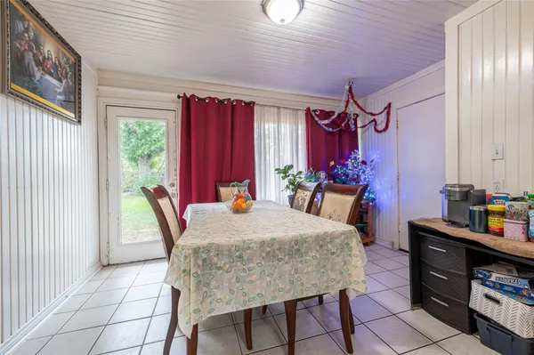 a dining room with furniture and window