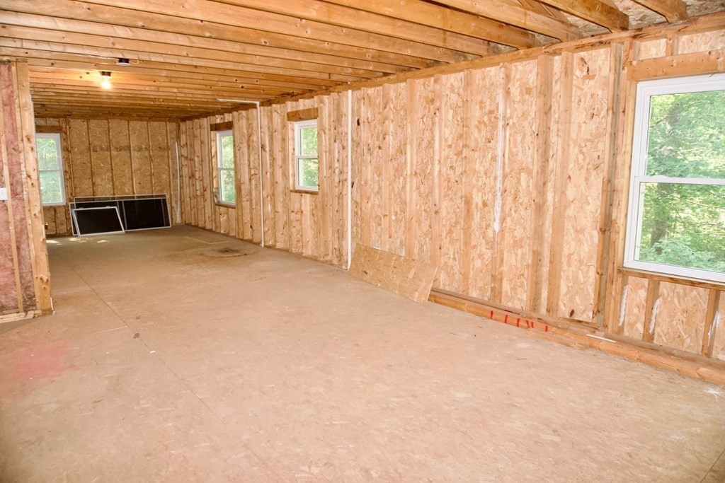 9 Pine Plain Road Georgetown, MA 01833 - Photo 20 of 26 a view of an empty room with a fireplace and a window