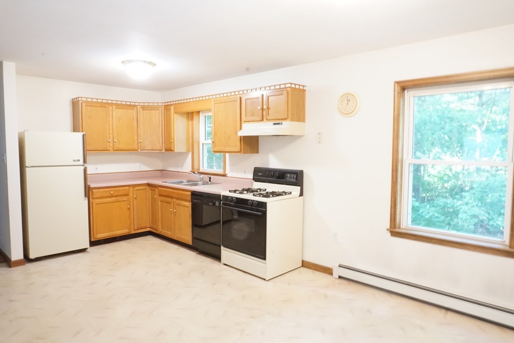 9 Pine Plain Road Georgetown, MA 01833 - Photo 3 of 26 a kitchen with a stove a sink and a refrigerator