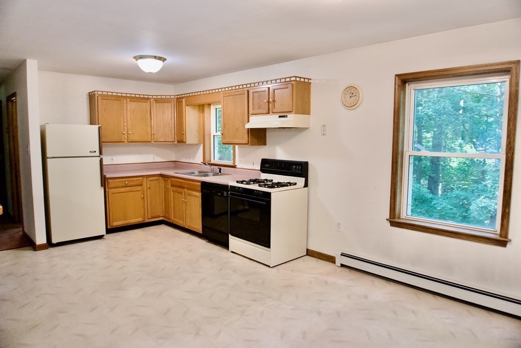 9 Pine Plain Road Georgetown, MA 01833 - Photo 6 of 26 a kitchen with stainless steel appliances granite countertop a stove a sink and a refrigerator
