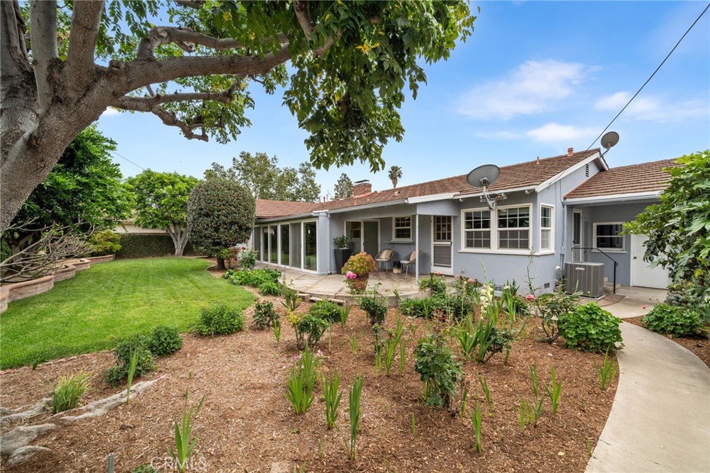 1107 Sharon Road Santa Ana, CA 92706 - Photo 15 of 37 a front view of a house with garden and porch