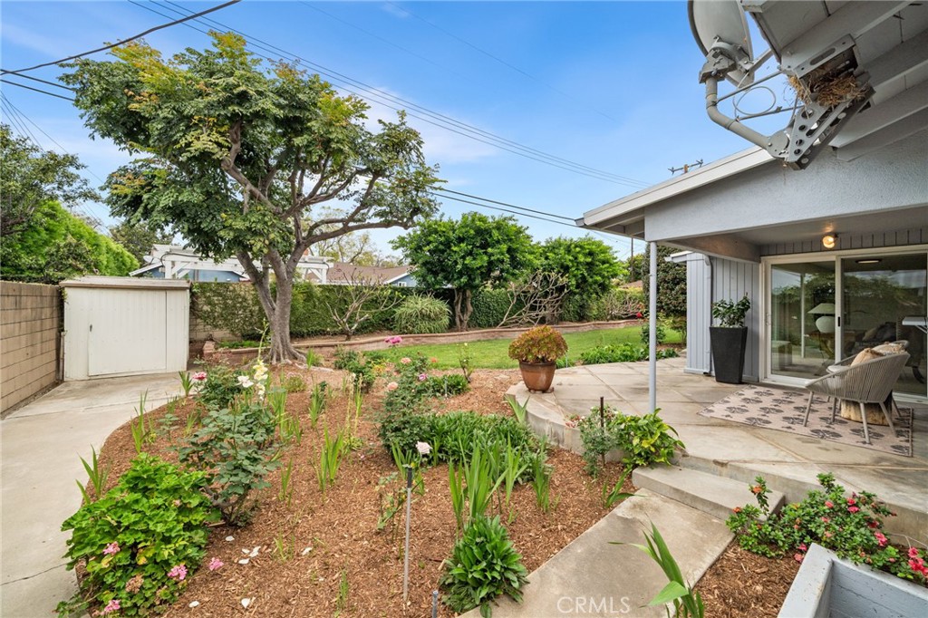 1107 Sharon Road Santa Ana, CA 92706 - Photo 17 of 37 a view of a patio with table and chairs potted plants and large tree