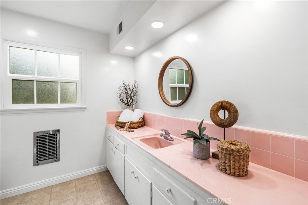1107 Sharon Road Santa Ana, CA 92706 - Photo 23 of 37 a bathroom with a sink mirror and vanity