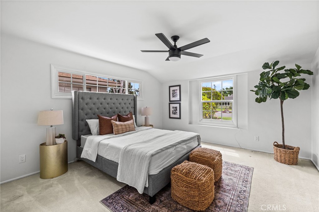 1107 Sharon Road Santa Ana, CA 92706 - Photo 25 of 37 a bedroom with a bed a couch and a potted plant