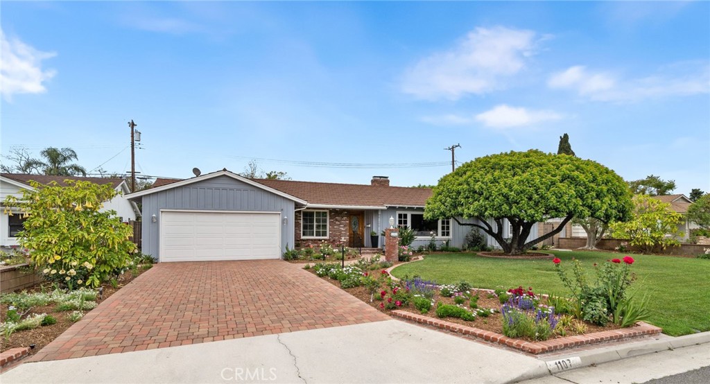 1107 Sharon Road Santa Ana, CA 92706 - Photo 35 of 37 a front view of a house with a garden