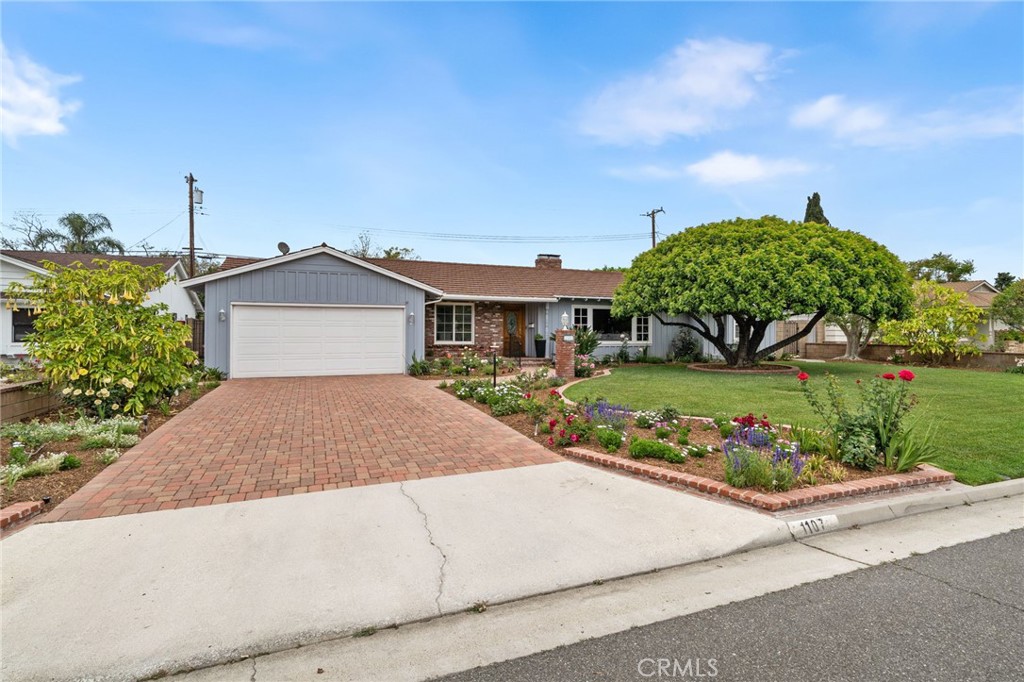1107 Sharon Road Santa Ana, CA 92706 - Photo 36 of 37 a front view of a house with a garden