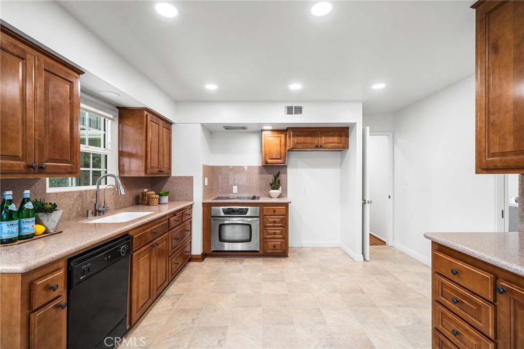 1107 Sharon Road Santa Ana, CA 92706 - Photo 8 of 37 a kitchen with a sink stove and refrigerator