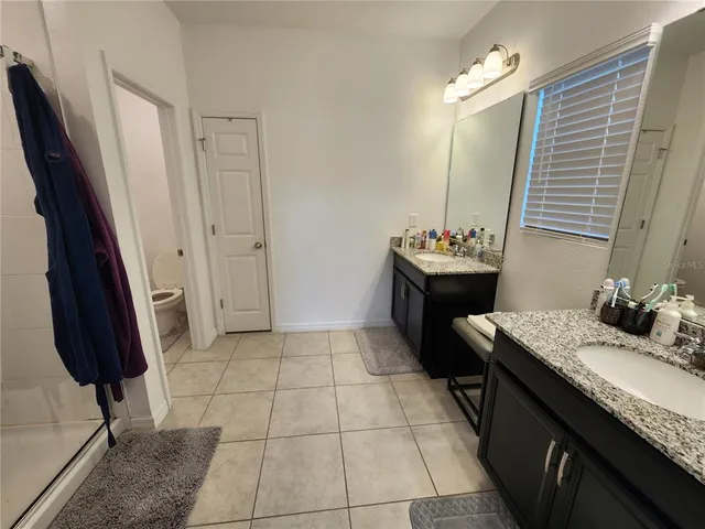 a bathroom with a sink vanity and mirror