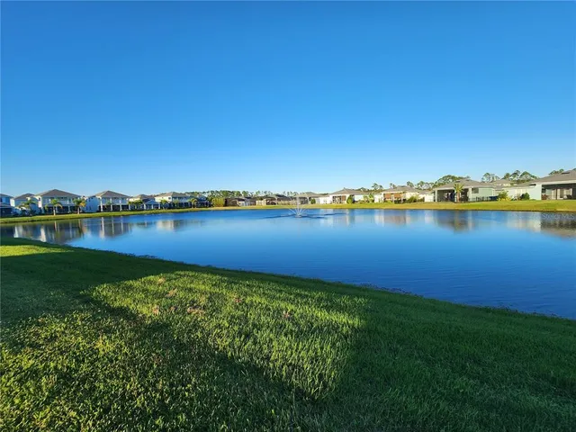 a view of a lake with houses in background