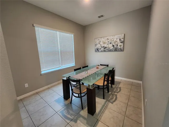 a dining room with a table and chairs