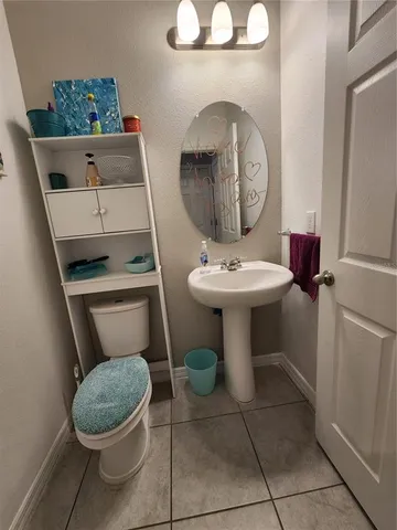 a bathroom with a toilet a sink and a mirror