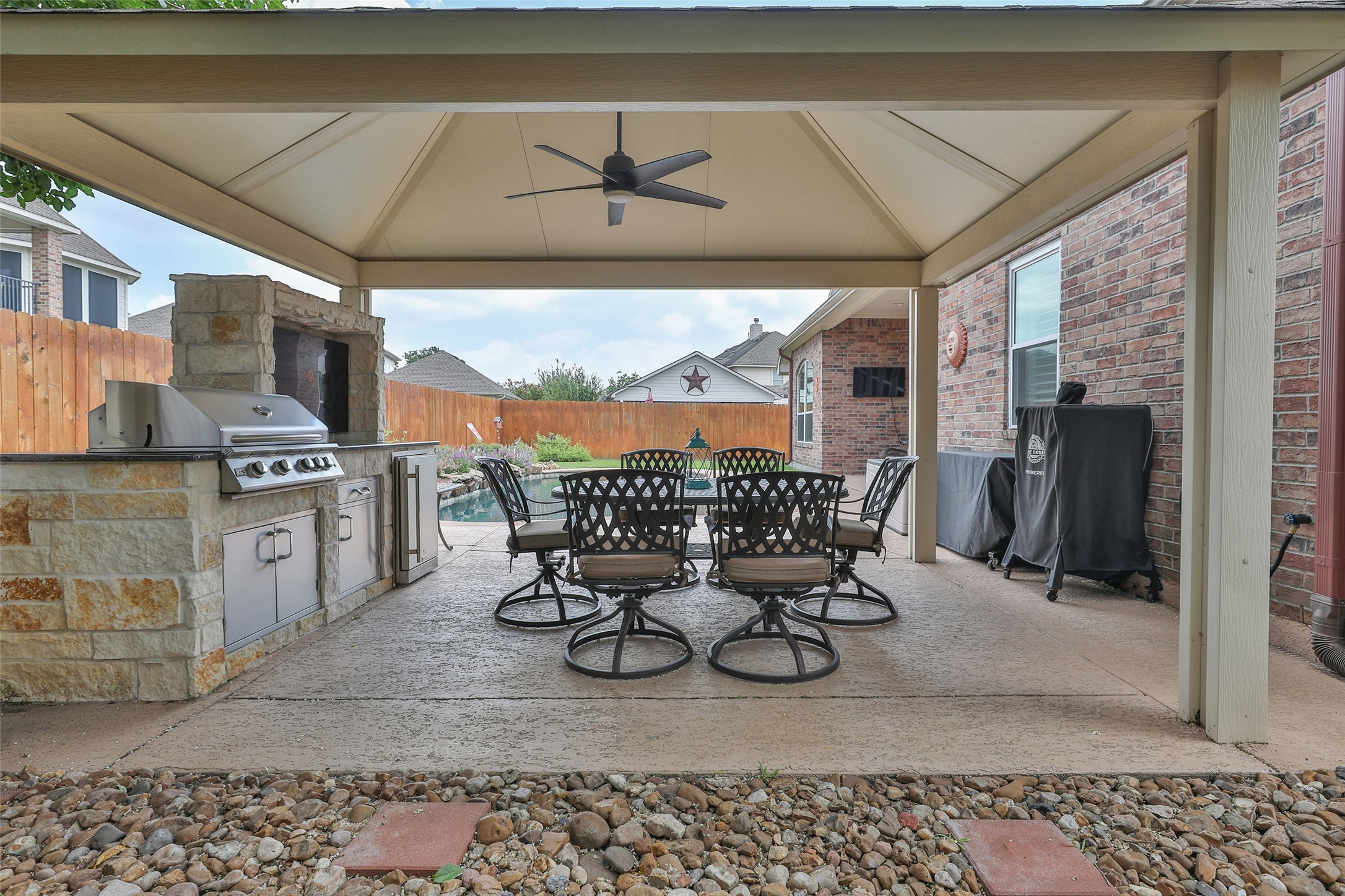 20519 Windrose Bend Drive Spring, TX 77379 - Photo 28 of 37 This backyard is an owner's dream! It features a covered back porch for relaxing, a sparkling pool to cool off in, and an additional covered patio complete with an outdoor kitchen —the perfect spot for entertaining guests or watching the big game.