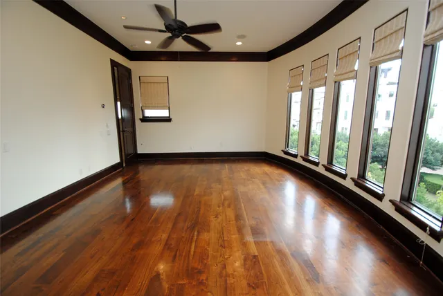 a large white kitchen with a large window appliances and cabinets