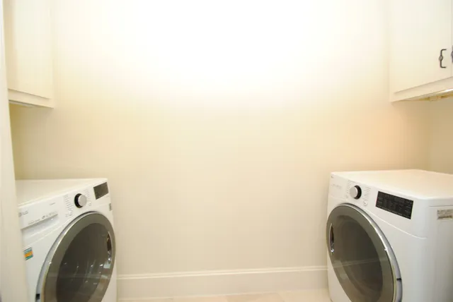 a view of an empty room with a chandelier