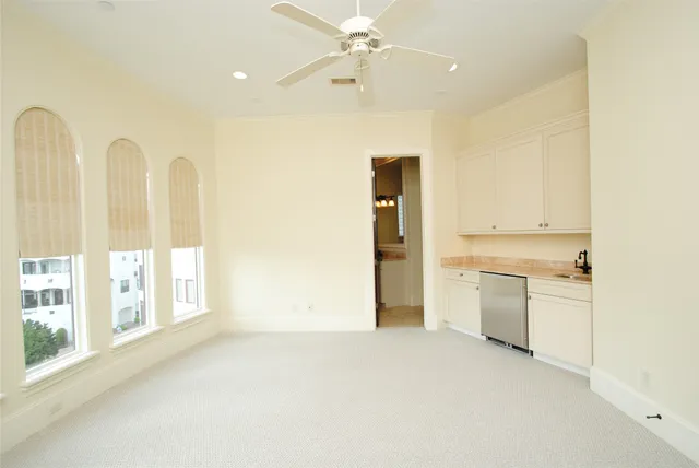 a view of a kitchen with furniture and a ceiling fan