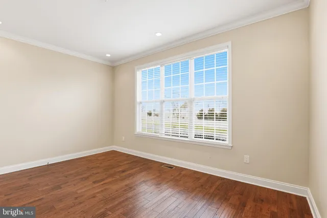 a kitchen with refrigerator cabinets and wooden floor