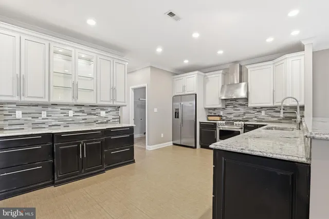 a kitchen with stainless steel appliances a sink stove and refrigerator