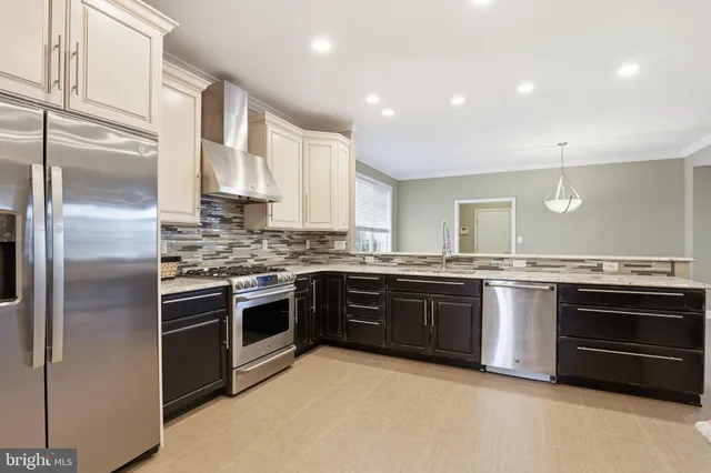 a view of kitchen with a refrigerator a sink and a counter top space