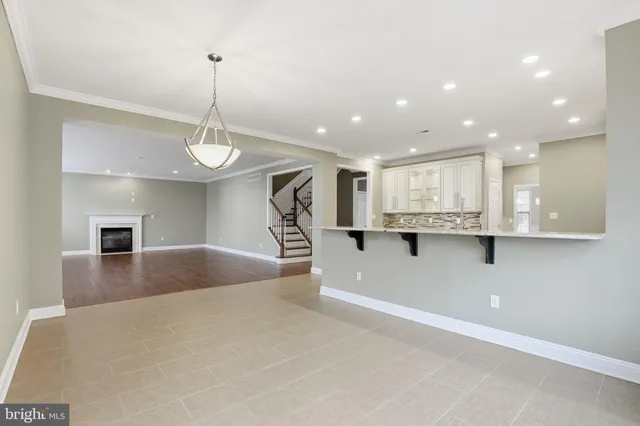 a view of kitchen with stainless steel appliances kitchen island sink and stove
