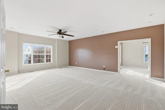 a view of empty room with ceiling fan