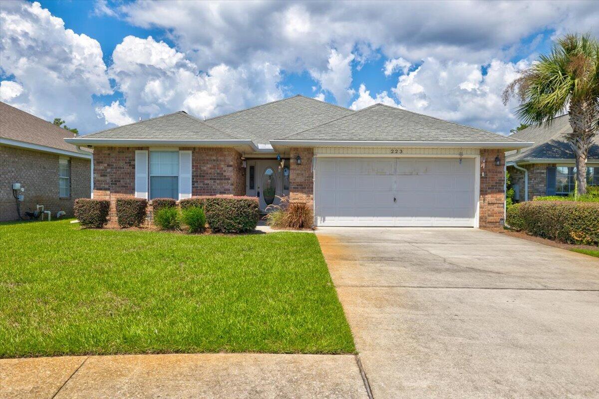 a front view of a house with a garden and a yard