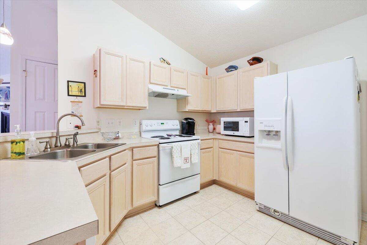 223 Sandy Cay Drive Miramar Beach, FL 32550 - Photo 15 of 25 a kitchen with white cabinets and white appliances