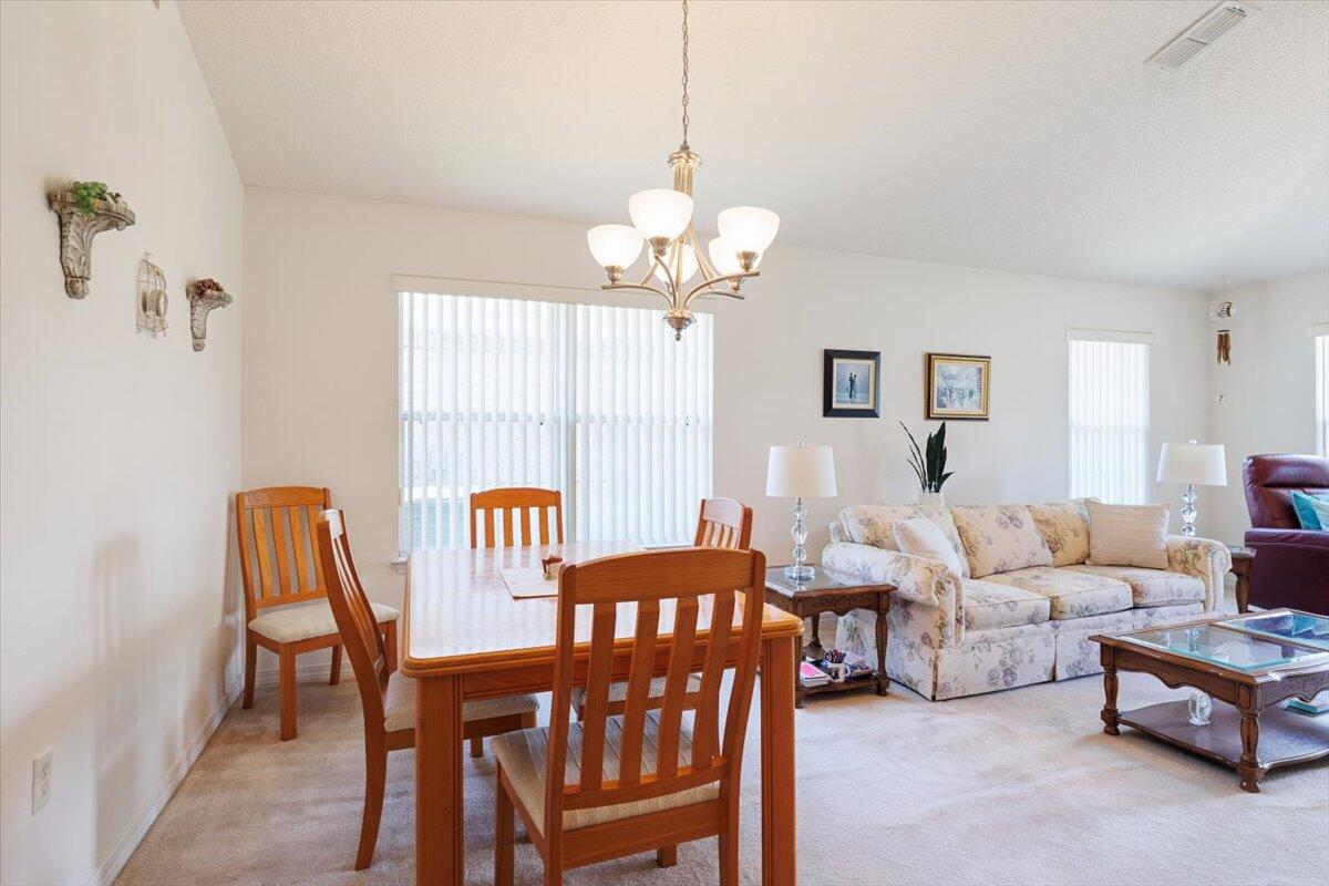 223 Sandy Cay Drive Miramar Beach, FL 32550 - Photo 7 of 25 a living room with furniture a chandelier a rug and a window