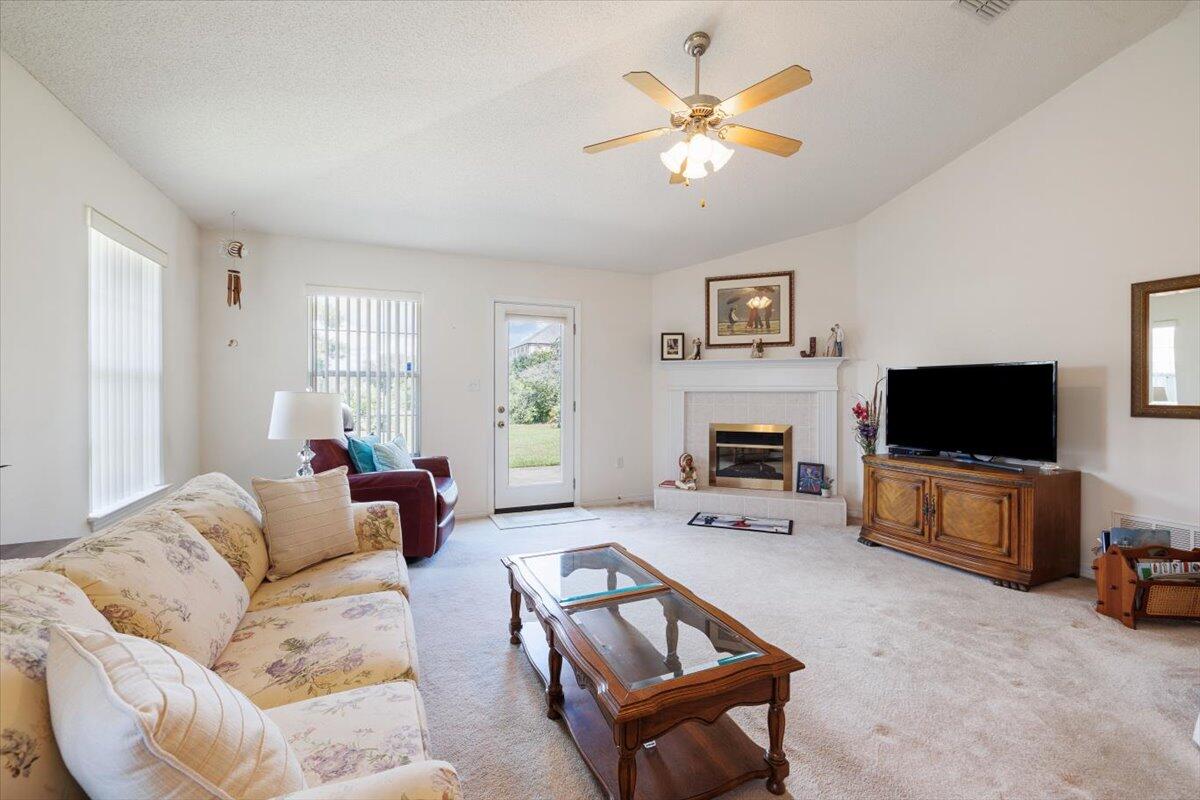 223 Sandy Cay Drive Miramar Beach, FL 32550 - Photo 9 of 25 a living room with furniture a flat screen tv and a window