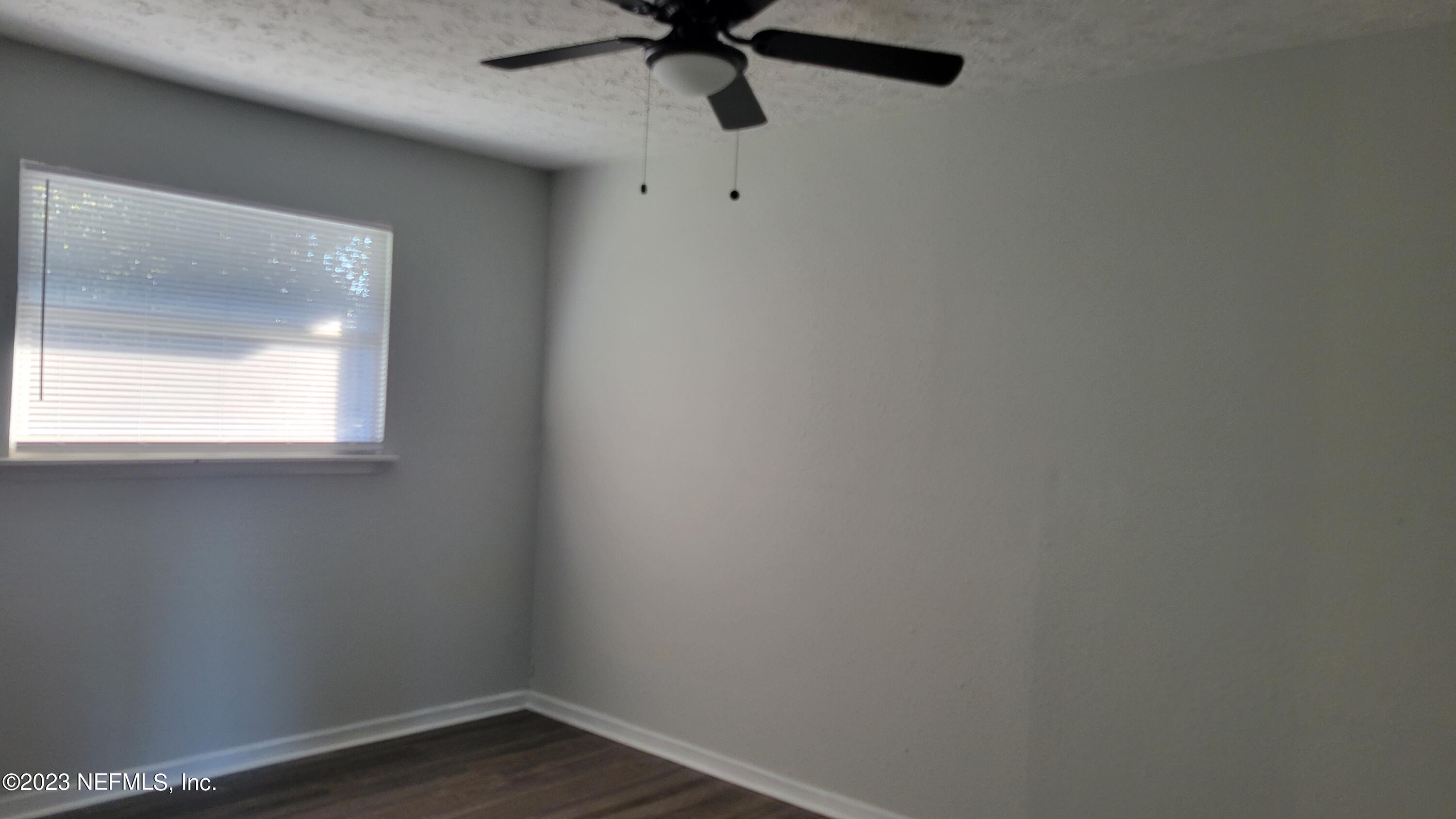 11685 Shellfish Drive Jacksonville, FL 32246 - Photo 13 of 32 a view of a small space with wooden floor and windows