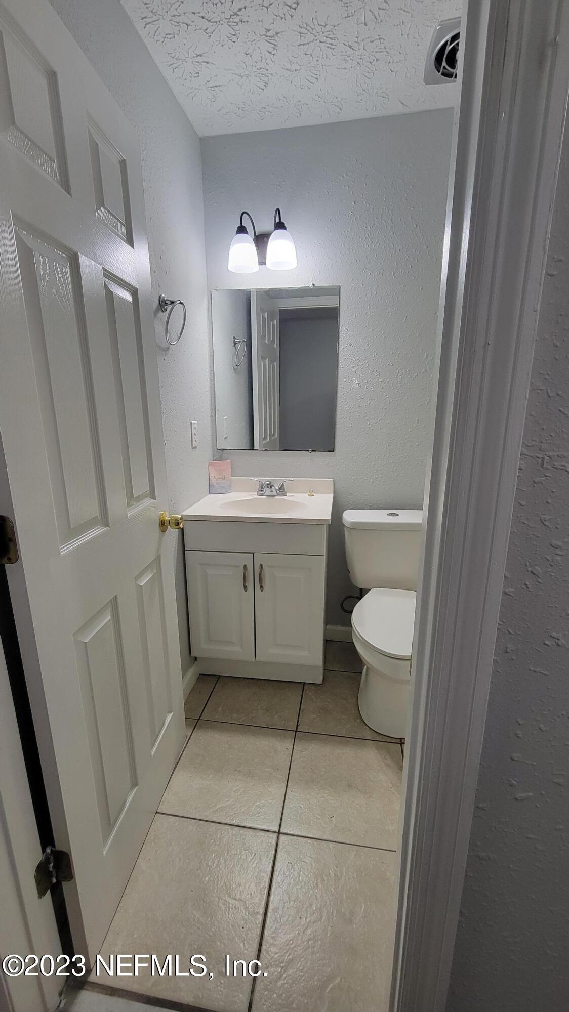 11685 Shellfish Drive Jacksonville, FL 32246 - Photo 16 of 32 a bathroom with a sink a toilet and a mirror