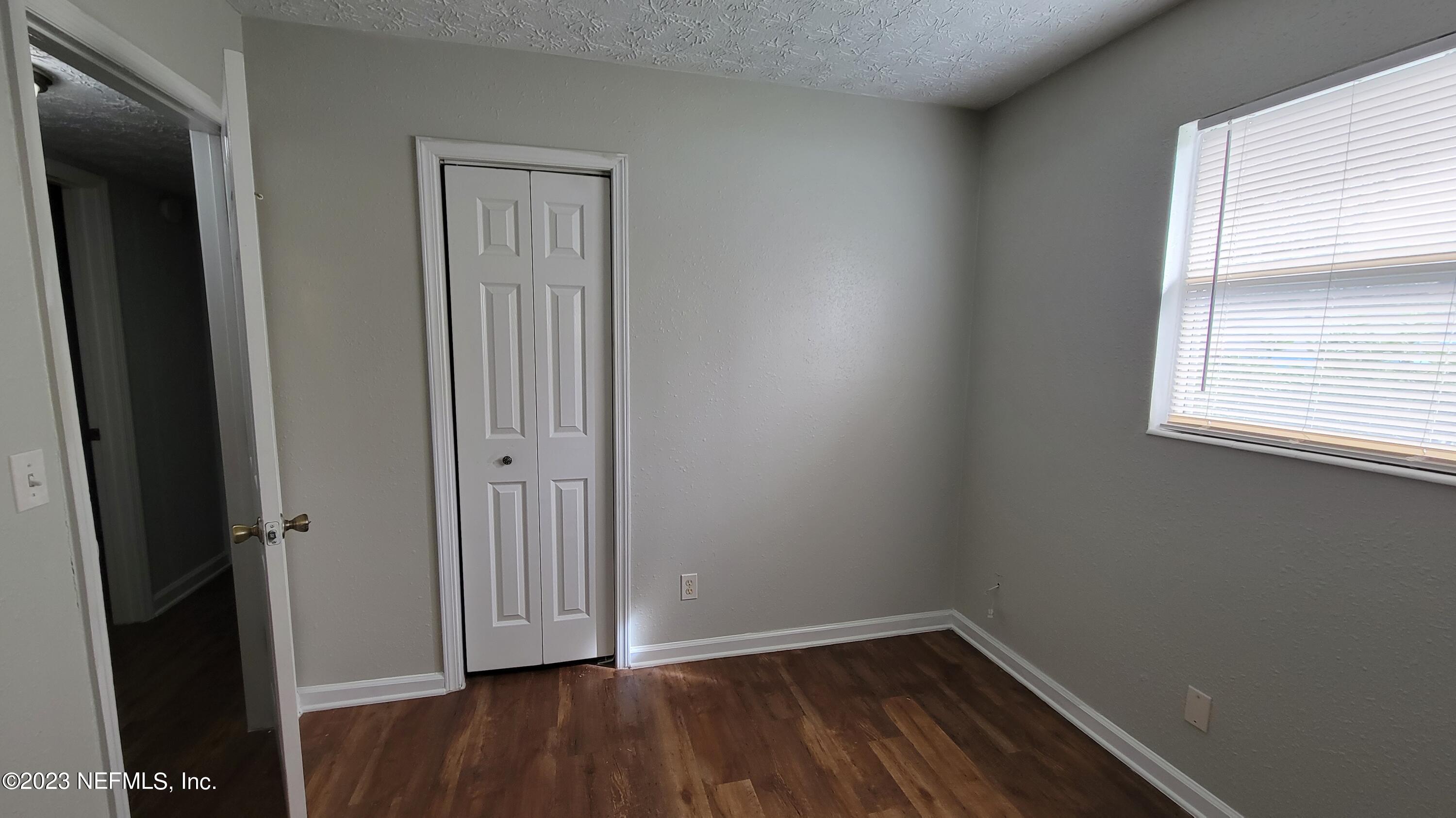 11685 Shellfish Drive Jacksonville, FL 32246 - Photo 20 of 32 an empty room with wooden floor and a window