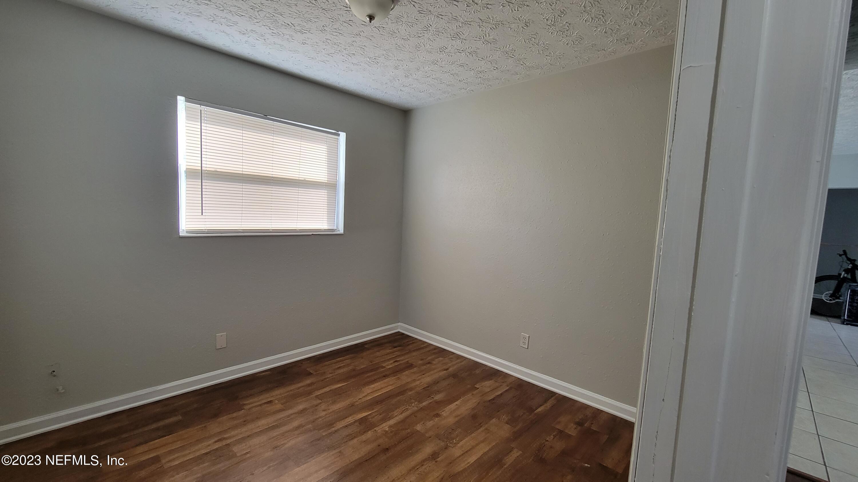 11685 Shellfish Drive Jacksonville, FL 32246 - Photo 22 of 32 a view of an empty room with wooden floor and a window