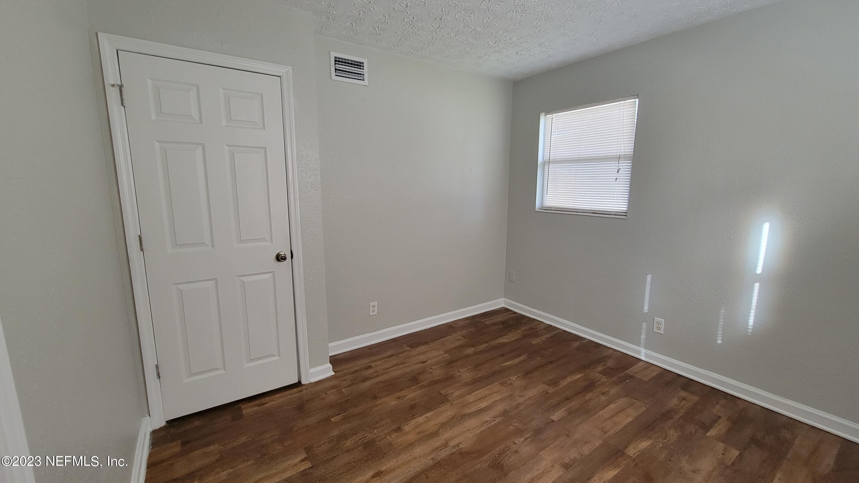 11685 Shellfish Drive Jacksonville, FL 32246 - Photo 24 of 32 an empty room with wooden floor and closet area