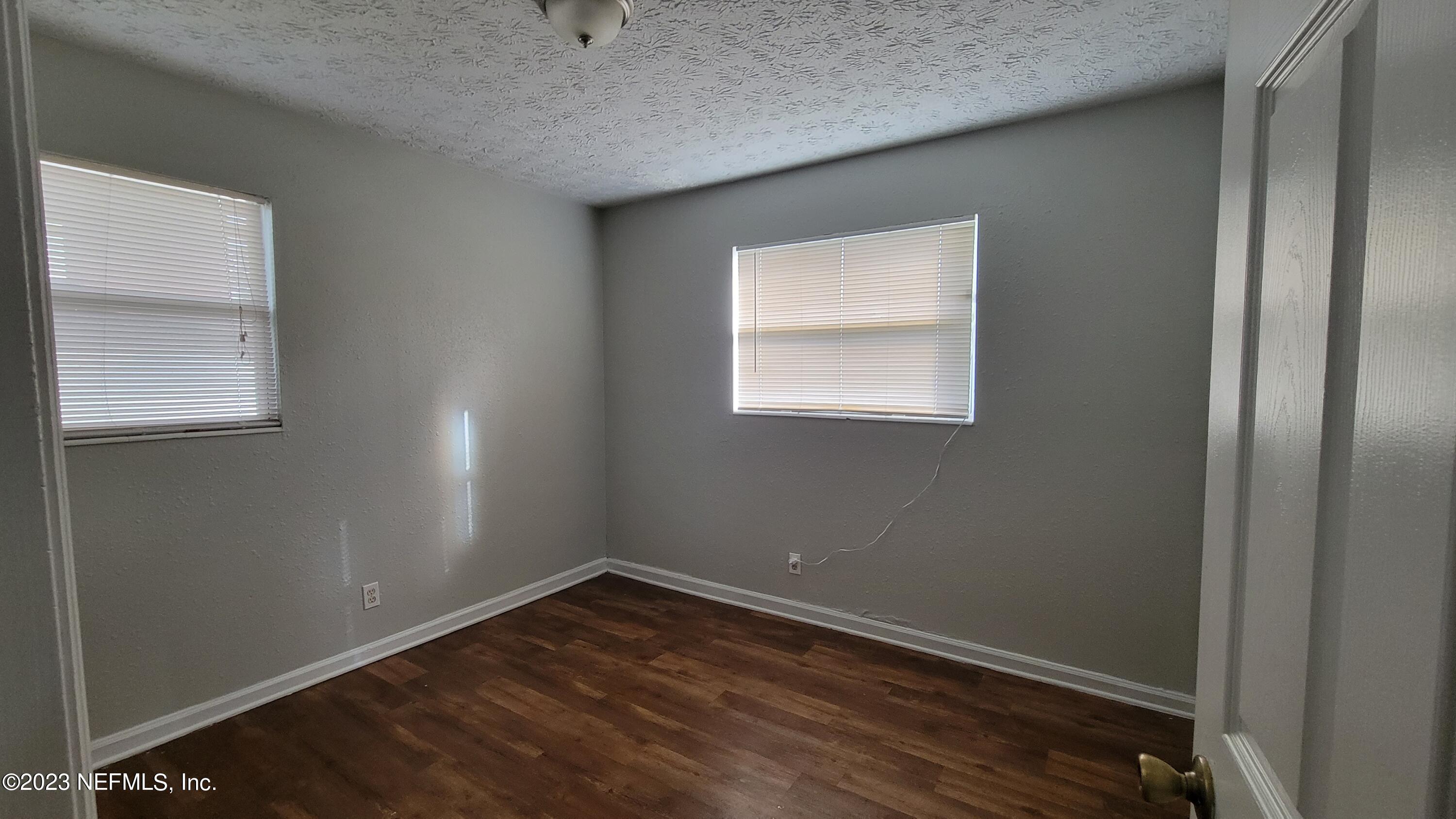 11685 Shellfish Drive Jacksonville, FL 32246 - Photo 25 of 32 a view of an empty room with wooden floor and a window